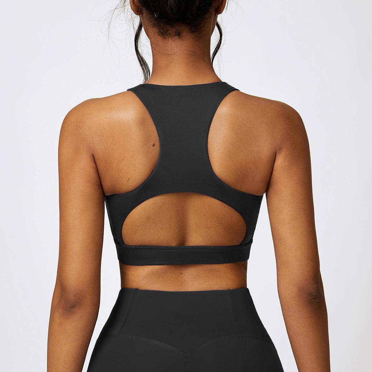 the back of a woman wearing a black sports bra