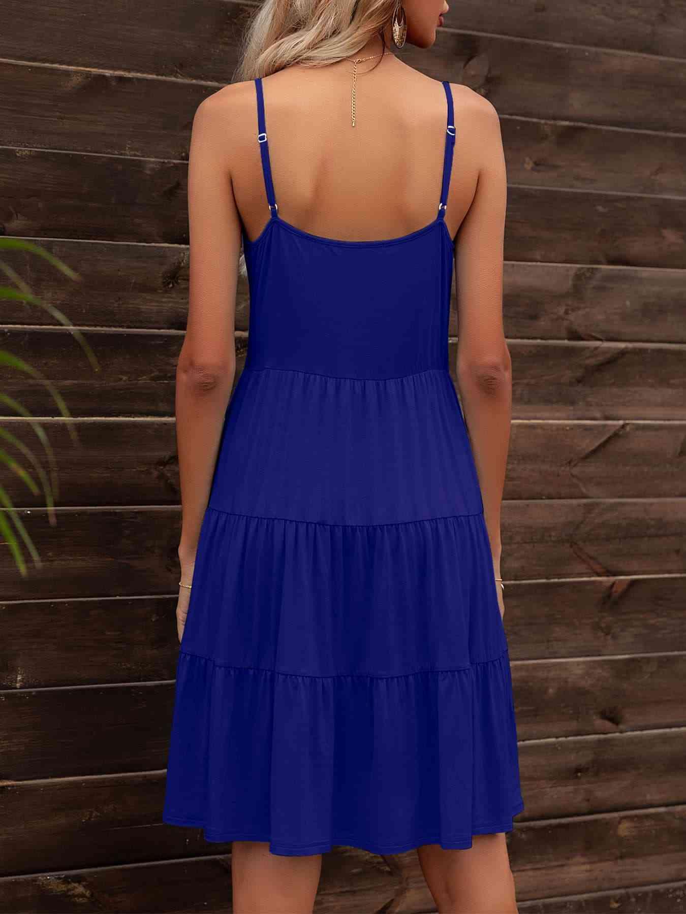 the back of a woman wearing a blue dress