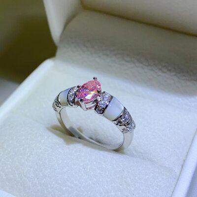 a pink and white diamond ring in a box