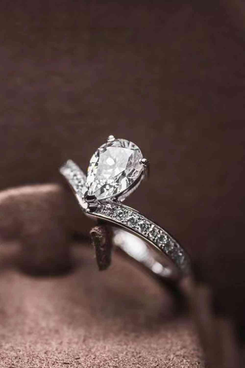 a close up of a ring with a diamond on it