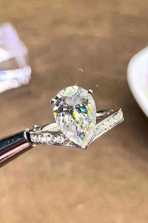 a heart shaped diamond being held by a pair of tongs