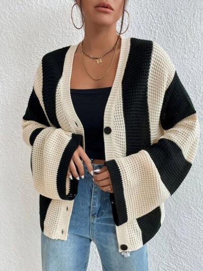 a woman wearing a black and white striped cardigan