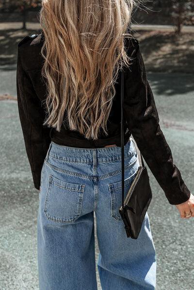 a woman with long hair walking down a street