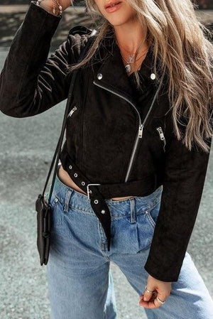 a woman wearing a black leather jacket and jeans