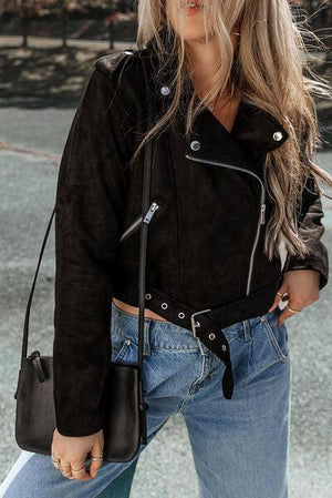 a woman with blonde hair wearing a black jacket and jeans