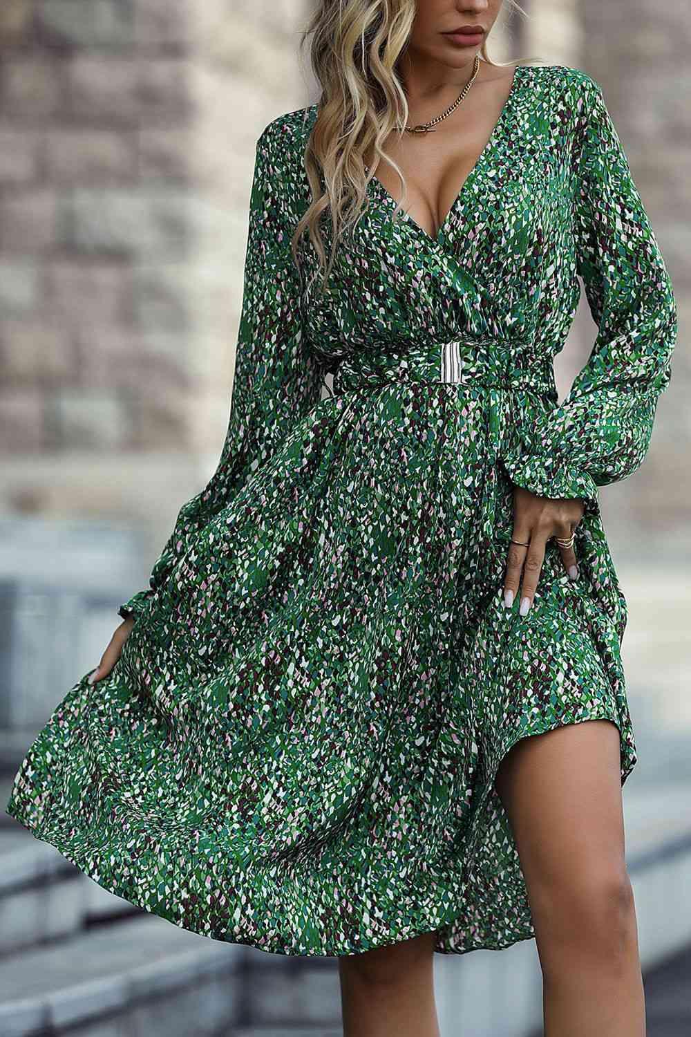 a woman wearing a green floral print dress