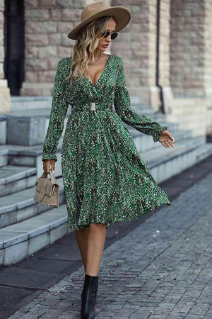 a woman in a green dress and hat walking down the street