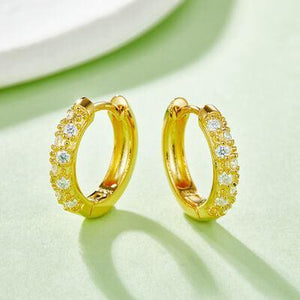 a pair of yellow gold hoop earrings with diamonds