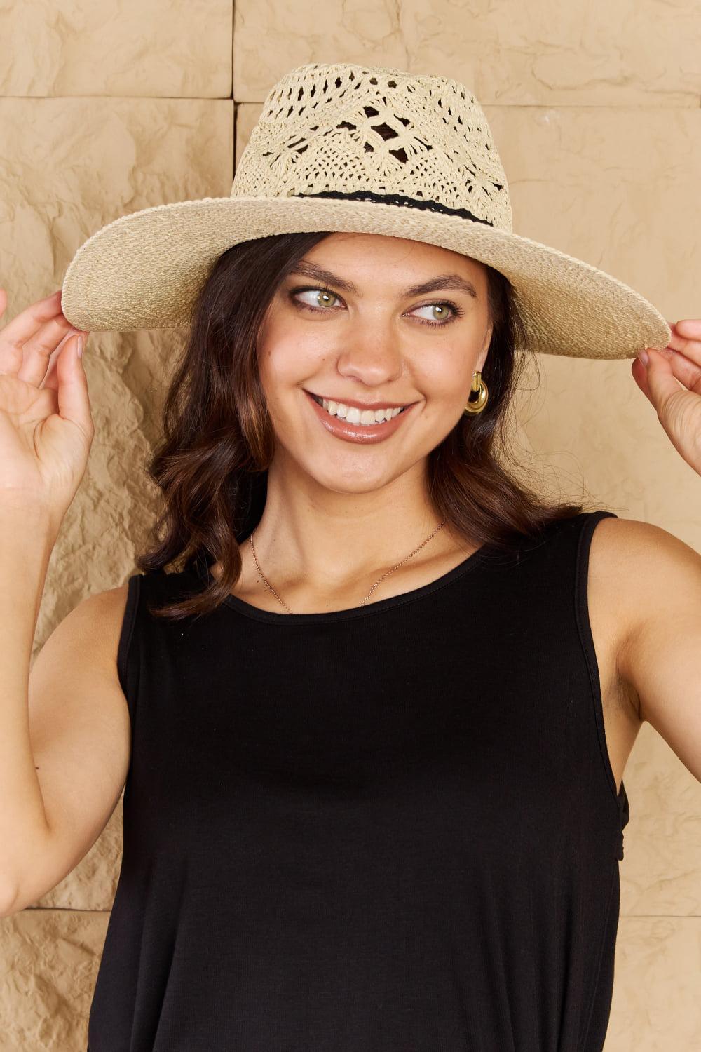 a woman in a black shirt and a white hat