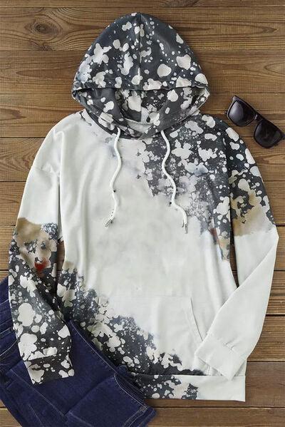 a white hoodie with black and white paint splattered on it