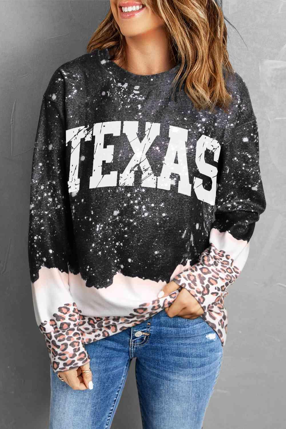 a woman wearing a sweatshirt with the word texas printed on it