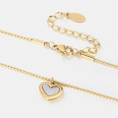 two gold and silver heart necklaces on a white background