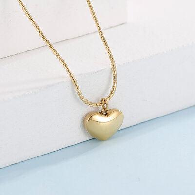a gold heart pendant on a gold chain