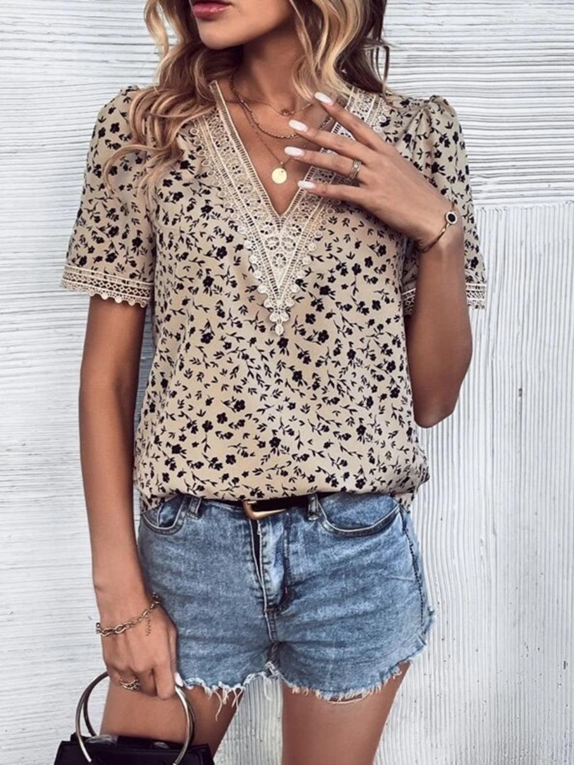 a woman wearing a leopard print shirt and denim shorts