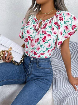 a woman sitting on a bed holding a white purse