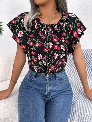 a woman sitting on a couch wearing jeans and a top