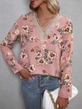 a woman wearing a pink floral blouse and jeans