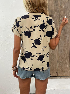 a woman in shorts and a floral shirt