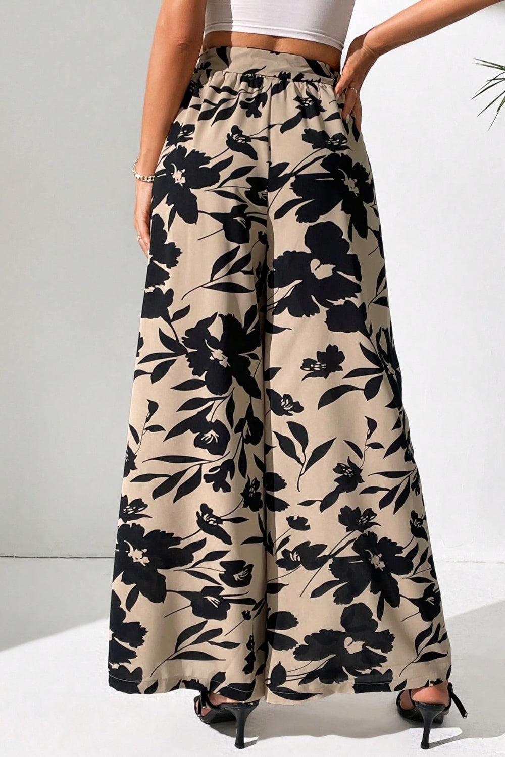 a woman in a crop top and floral print pants