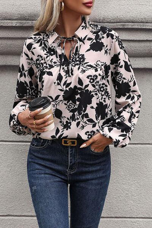 a woman wearing a black and white shirt and jeans