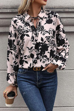 a woman wearing a black and white floral shirt