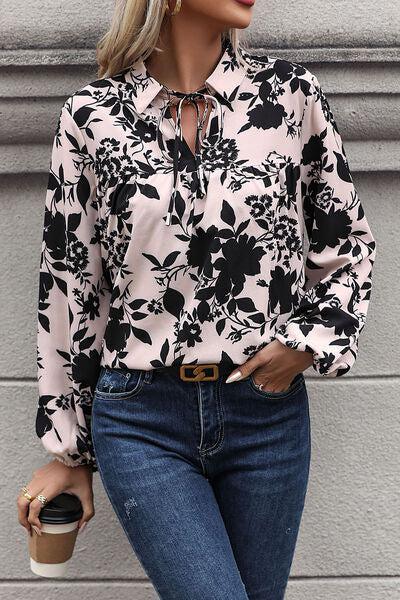 a woman wearing a black and white floral shirt