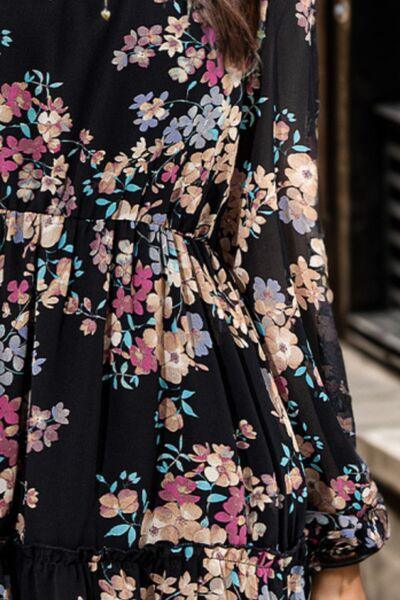 a woman wearing a black floral print dress