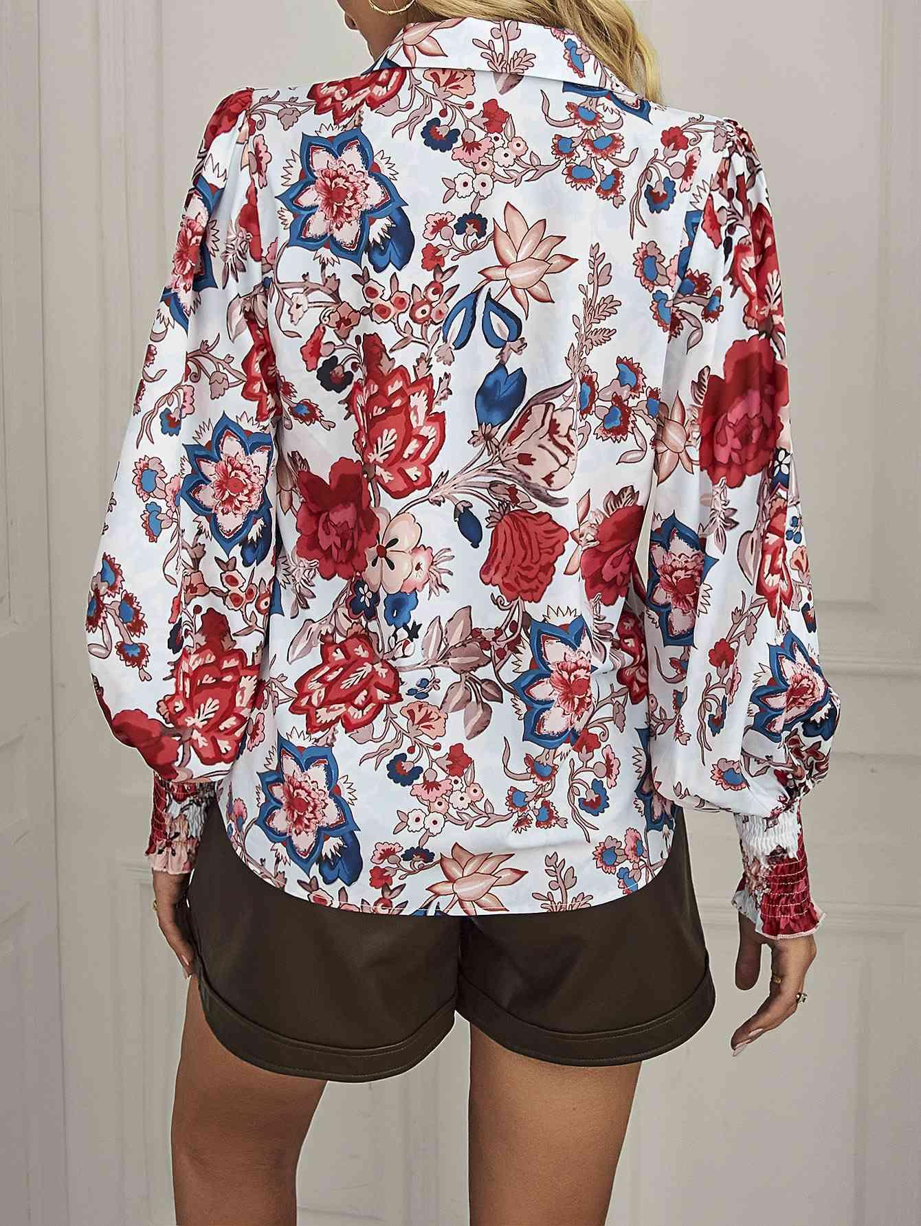 a woman wearing a floral shirt and shorts