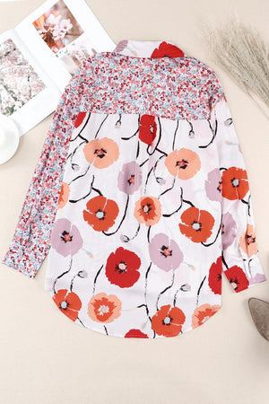 a white shirt with red and pink flowers on it