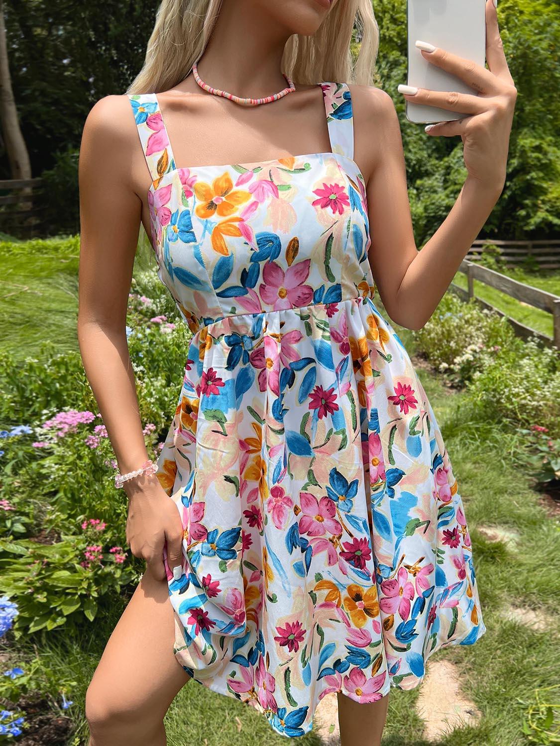 a woman in a floral dress holding a cell phone