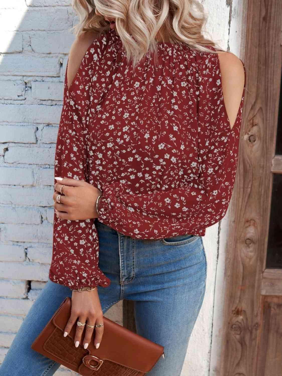 a woman wearing a red blouse and jeans