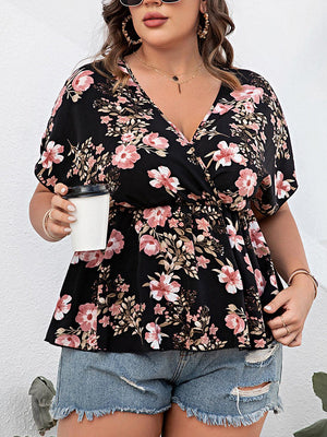 a woman in a floral top holding a coffee cup