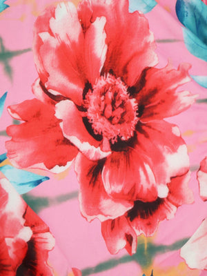 a red flower is on a pink background