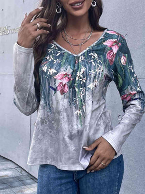 a woman in jeans and a top with flowers on it