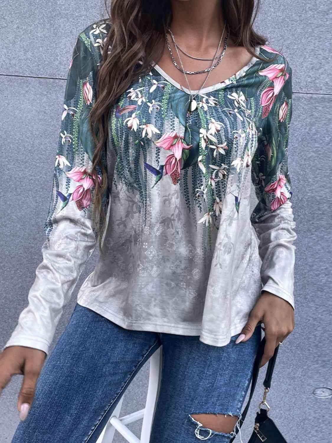 a woman wearing ripped jeans and a floral top