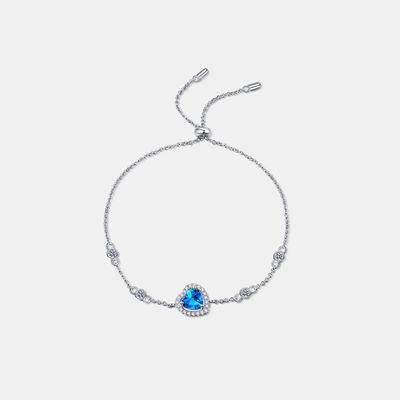 a bracelet with a blue stone on a white background