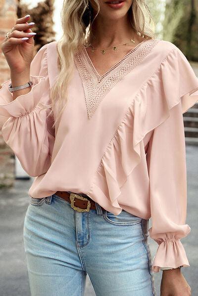 a woman wearing a pink blouse and jeans