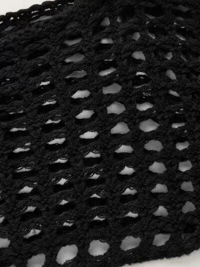 a close up of a black crochet shawl