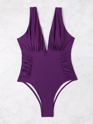 a purple one piece swimsuit on a white background