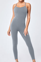 a woman in a grey bodysuit posing for a picture