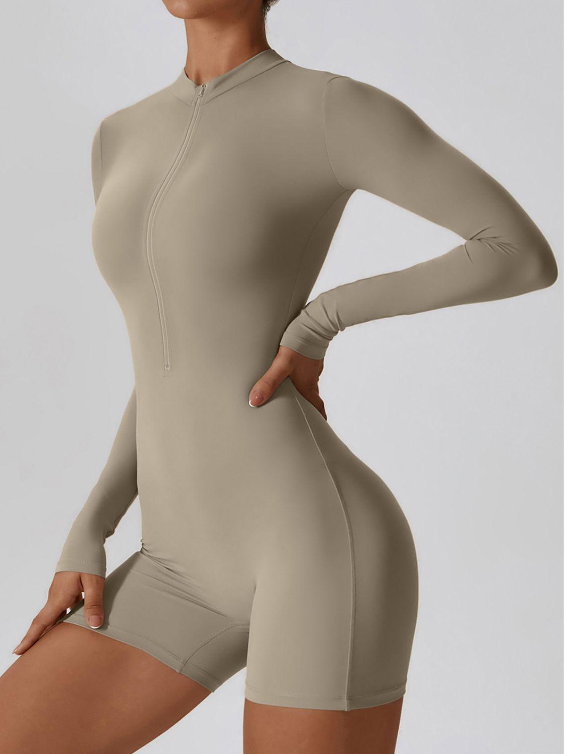 a woman in a bodysuit with her hands on her hips