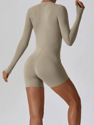 a woman in a tan bodysuit