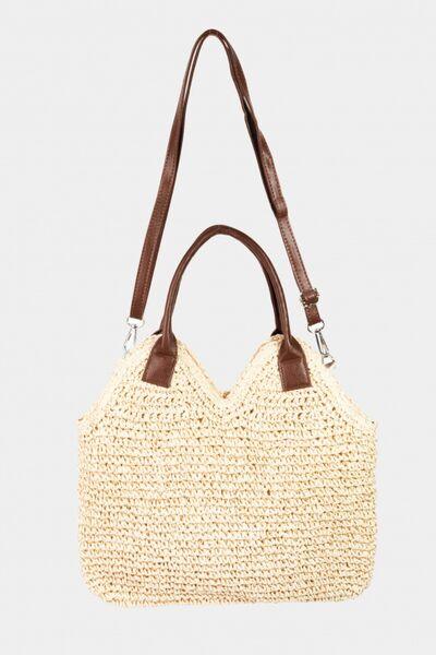 a straw bag with a brown leather handle