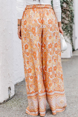 a woman wearing a white top and orange pants