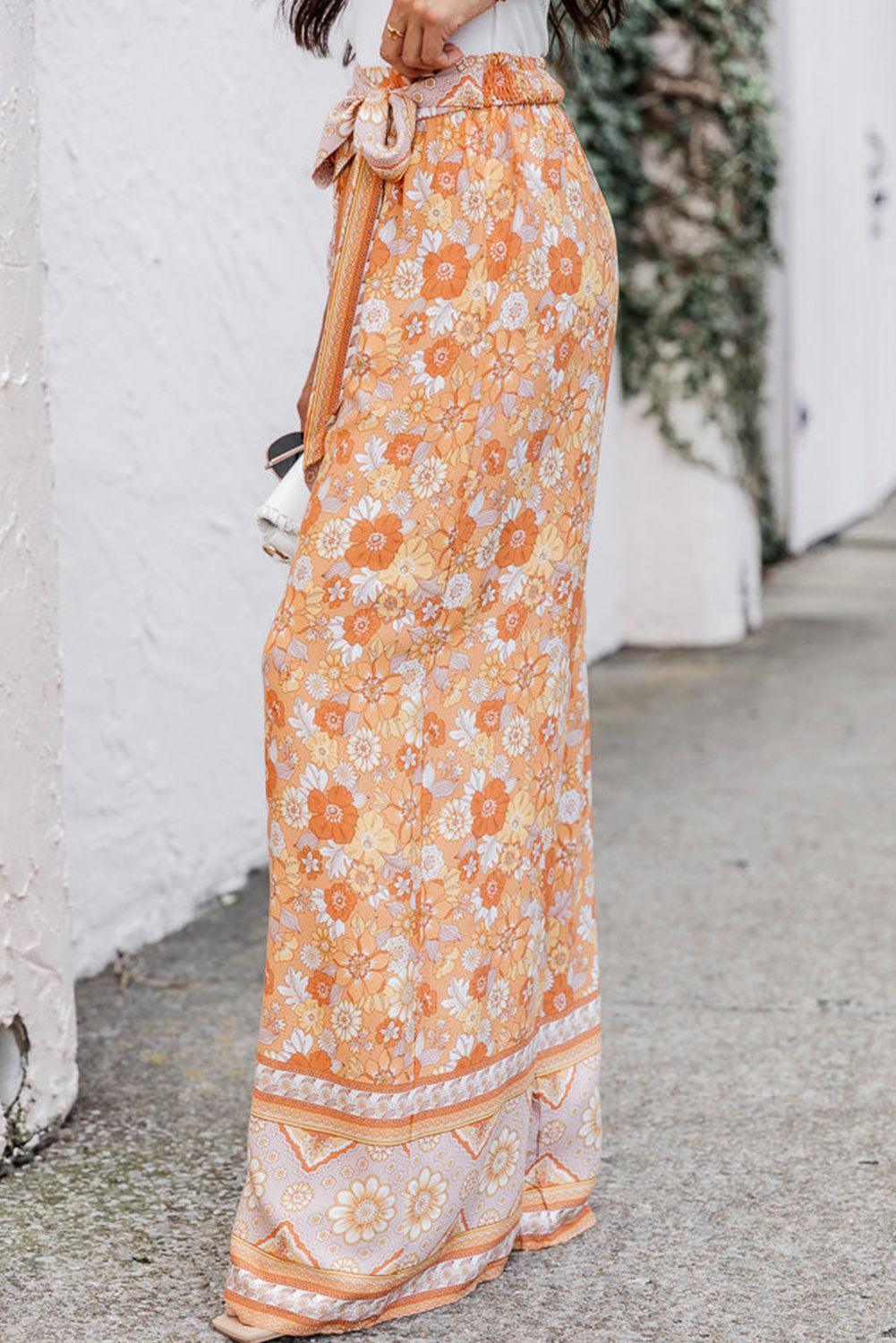 a woman in an orange and white floral print skirt