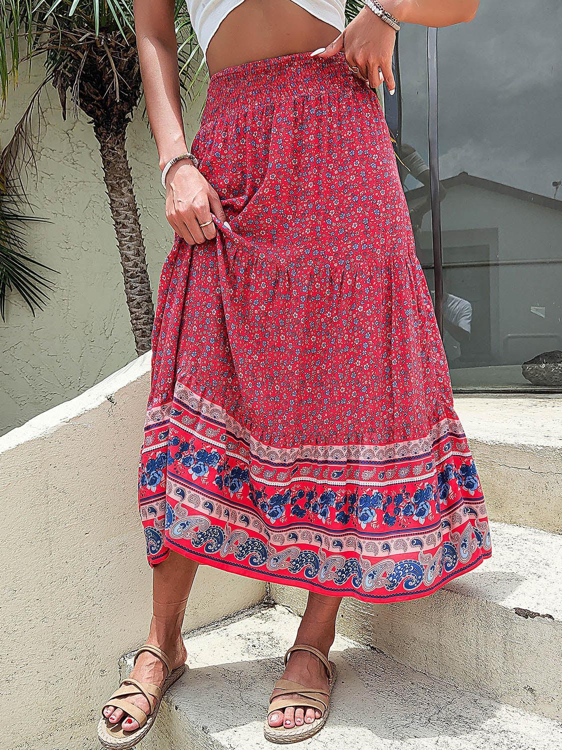 a woman in a red skirt standing on steps