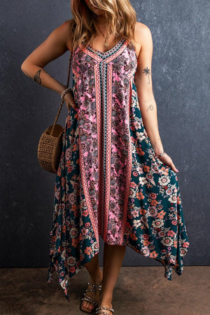 a woman in a floral dress poses for a picture