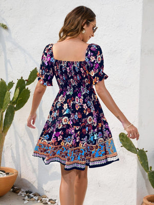 a woman in a floral print dress walking away from a cactus