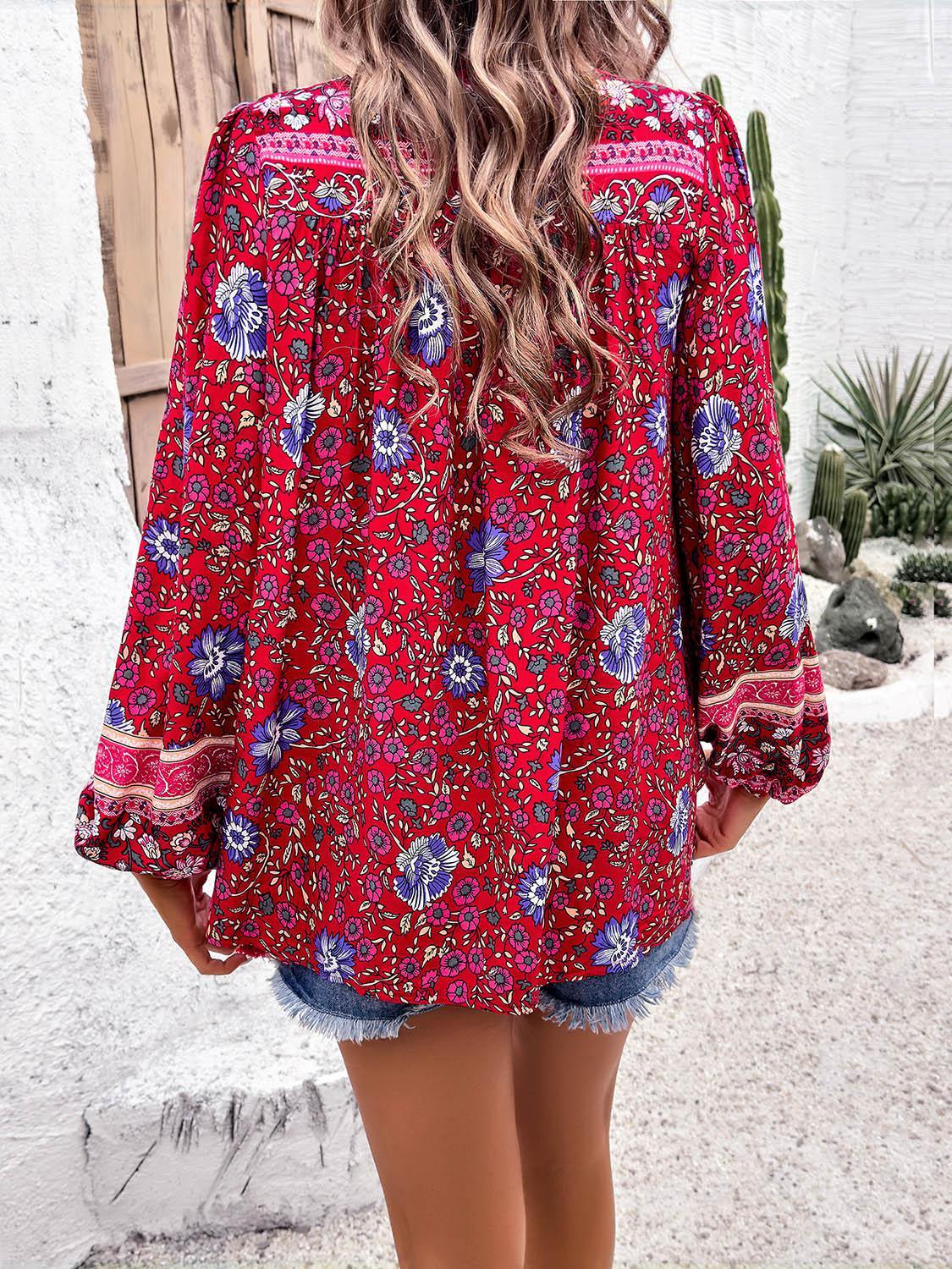 the back of a woman's red blouse with a floral pattern