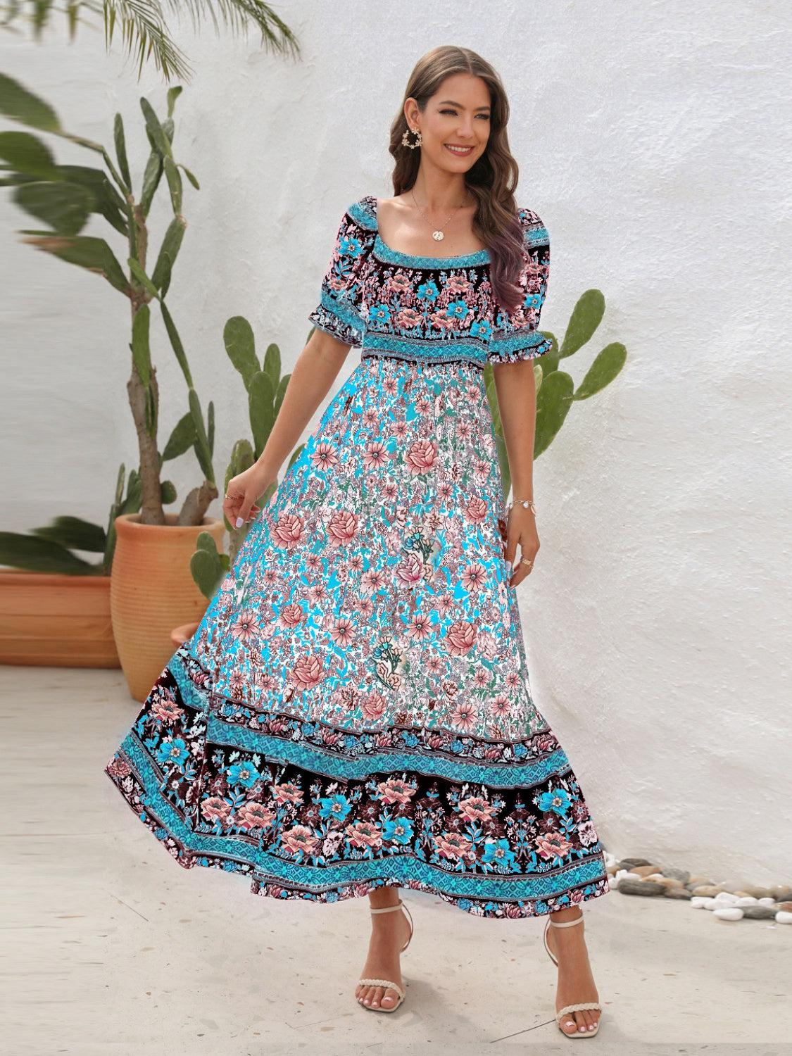 a woman in a blue and pink dress standing in front of a potted plant